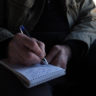 Dan Rather writing in his reporter's notebook