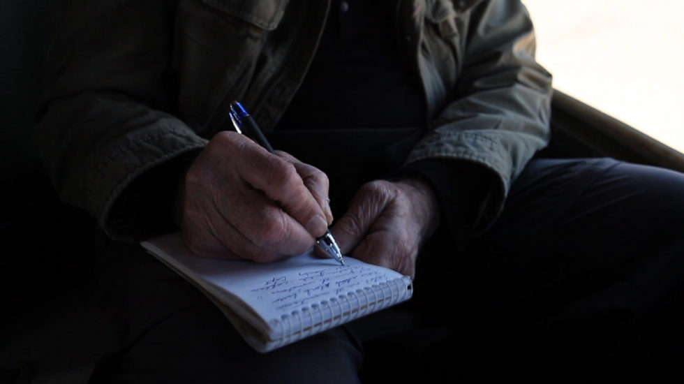 Dan Rather writing in his reporter's notebook