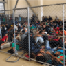 migrant children huddle together in cramped quarters at facility run by the Border Patrol in Donna, Texas